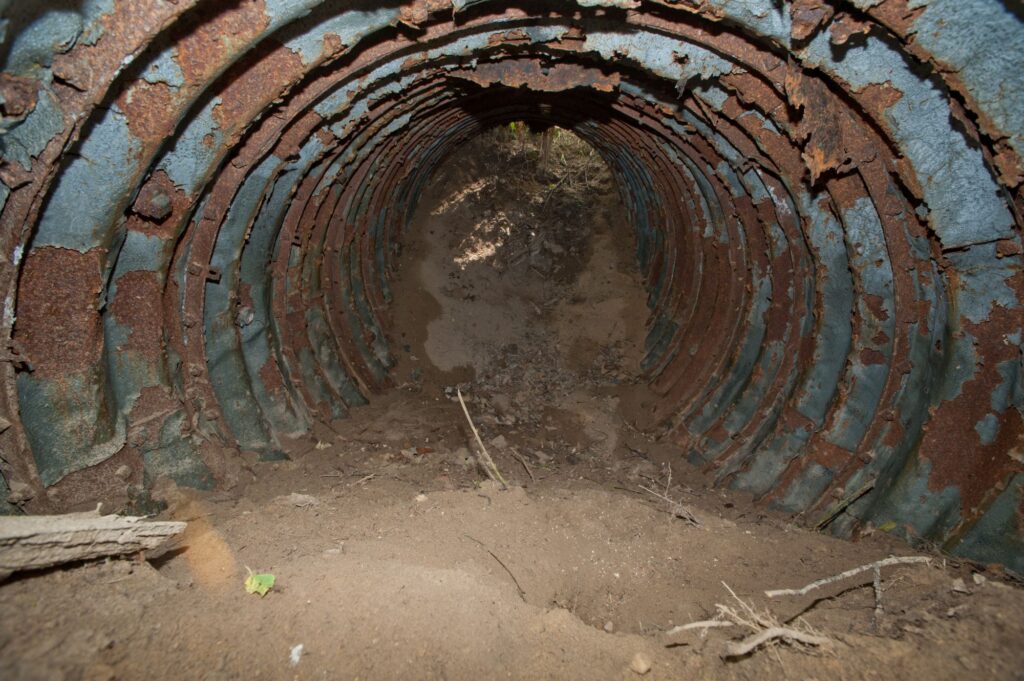 View of a buried segment of the spy tunnel, filled with earth