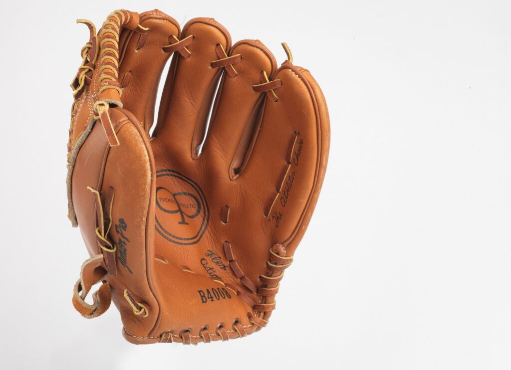 Brown leather glove with an indentation in the middle for catching a softball 