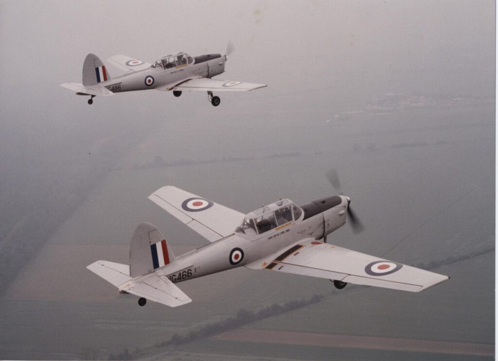 Two Royal Air Force Chipmunk airplanes flying alongside each other.
